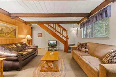 a living room with leather couches and a tv at Cabin #10 in Strawberry