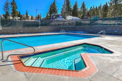 a swimming pool in a yard with a brick wall at Heavenly Mountain Lake Retreat Near Skiing, Hiking & Biking in Stateline