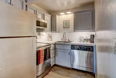 a kitchen with stainless steel appliances and white cabinets at Heavenly Mountain Lake Retreat Near Skiing, Hiking & Biking in Stateline