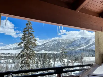 a view of a snowy mountain from a window at Bridges #308 condo in Mammoth Lakes