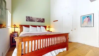 a bedroom with a bed and two lamps and a door at Bridges #308 condo in Mammoth Lakes