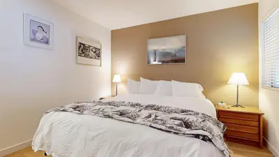 a bedroom with a large white bed and two lamps at Bridges #308 condo in Mammoth Lakes