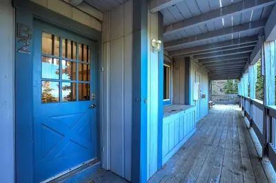 an empty porch with a blue door on a house at Spacious Lakeview Heavenly Mountain Escape! in Stateline