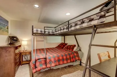 a bedroom with two bunk beds and a desk at Spacious Lakeview Heavenly Mountain Escape! in Stateline