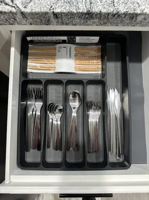 a drawer filled with utensils in a drawerlictsangering at Cozy Getaway with King bed & 70inTV in Carmichael