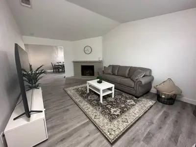 a living room with a couch and a fireplace at Cozy Getaway with King bed & 70inTV in Carmichael