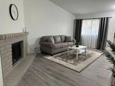 a living room with a couch and a fireplace at Cozy Getaway with King bed & 70inTV in Carmichael
