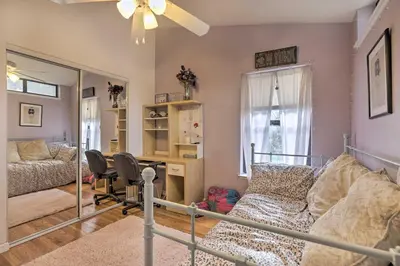 a bedroom with a bed and a desk at Homey Colfax Getaway with Private Hot Tub! in Colfax