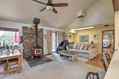 a living room with a couch and a fireplace at Homey Colfax Getaway with Private Hot Tub! in Colfax