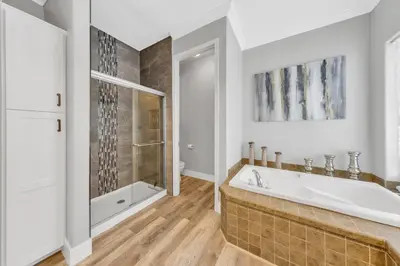 a white bathroom with a tub and a shower at Luxe & Comfy Vineyard Estate ~ Breathtaking Views! in Clarksburg