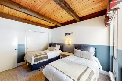 a bedroom with two beds and a wooden ceiling at Kingswood Village 60 in Kings Beach