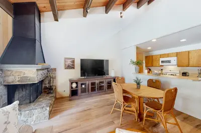 a living room with a table and a fireplace at Kingswood Village 60 in Kings Beach