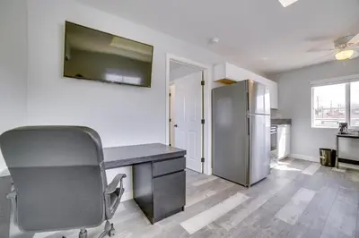 an office with a desk and a refrigerator at Renovated Hawthorne Apartment By Museums and Dining! in Hawthorne