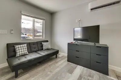 a living room with a couch and a flat screen tv at Updated Hawthorne Apartment, 12 Mi to Walker Lake! in Hawthorne