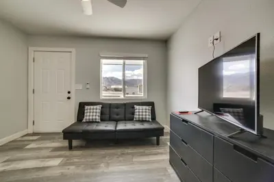 a living room with a couch and a tv at Updated Hawthorne Apartment, 12 Mi to Walker Lake! in Hawthorne