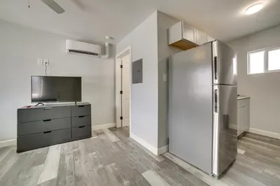 a kitchen with a stainless steel refrigerator and wooden floors at Updated Hawthorne Apartment, 12 Mi to Walker Lake! in Hawthorne