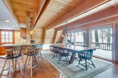 a kitchen with a wooden ceiling and a table and chairs at Donner Lake Views Rustic Truckee Cabin! in Truckee