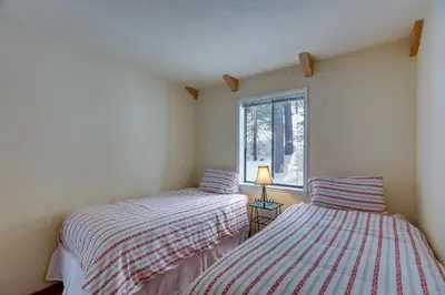 two beds in a room with a window at Donner Lake Views Rustic Truckee Cabin! in Truckee