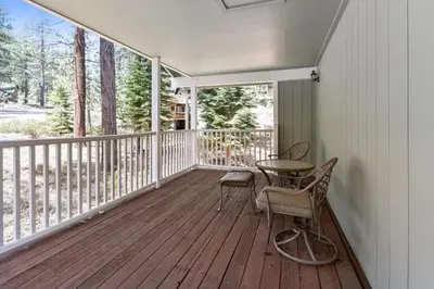 a porch with a table and chairs on it at Minutes To Heavenly, Private Covered Hot Tub in South Lake Tahoe