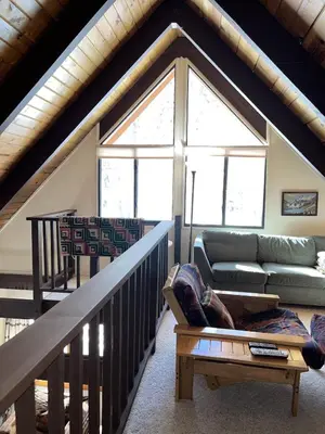 a living room with a couch and a large window at Cabin Close To Hiking Trails And Ski Resorts in South Lake Tahoe