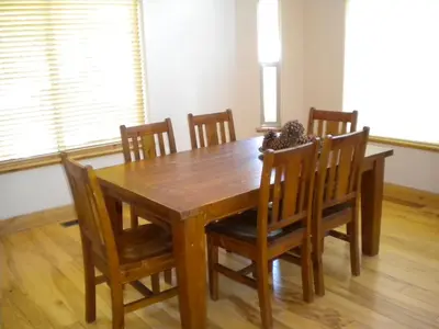 a dining room table with chairs and a wooden table at Close To Everything Newly Built With Games Room in South Lake Tahoe