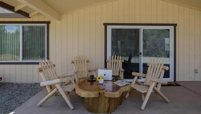 a wooden table and four chairs on a patio at Bear Paw Cabin new construction near Yosemite in Mariposa