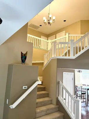 a staircase in a house with a dining room at Serenity in Fresno