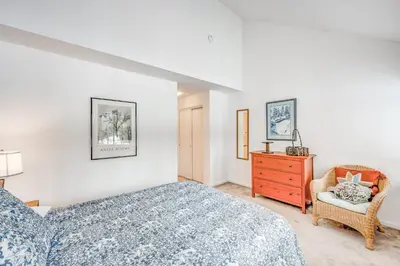 a bedroom with a bed and a chair and a dresser at Championship Pines in Incline Village