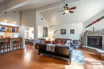 a living room with a couch and a fireplace at Forest Cabin by China Creek in Oakhurst