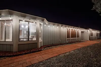 a building with lights on the side of it at night at Cherry Cottage 15 min from Yosemite South Entrance in Oakhurst