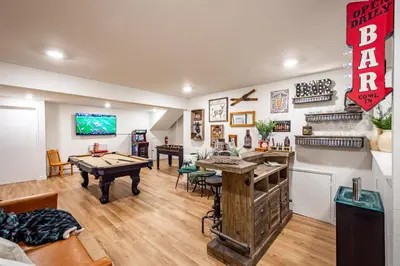 a living room with a ping pong table in it at Sugarpine Trailhead Lodge at Lewis Creek Upper Trailhead just 7 miles from Yosemite in Oakhurst