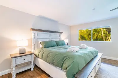 a bedroom with a large bed with a window at Mystic Mountain Villa, 14 miles from Yosemite in Oakhurst