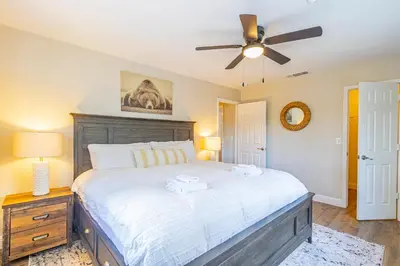 a bedroom with a large bed and a ceiling fan at Mystic Mountain Villa, 14 miles from Yosemite in Oakhurst