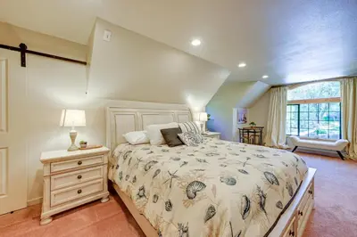 a bedroom with a large bed and a window at Lakeside Bear Lodge Studio 9 Mi to Bass Lake! in Bass Lake Annex