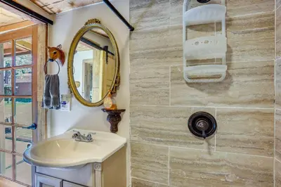 a bathroom with a sink and a mirror at 9 Mi to Bass Lake Cabin with Fire Pit in Wishon! in Bass Lake Annex