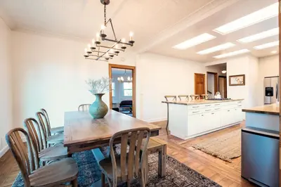 a kitchen and dining room with a wooden table and chairs at Yosemite Country House sleeps 20 w/ hot tub, firepit, bonus studio in Oakhurst