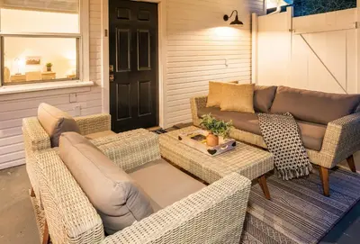 a patio with a couch and chairs and a table at Yosemite Country House sleeps 20 w/ hot tub, firepit, bonus studio in Oakhurst