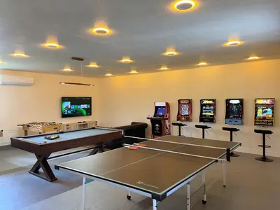 a gaming room with ping pong tables and slot machines at Log Cabin sleeps 20 with hot tub, EV Charger, firepit in Ahwahnee