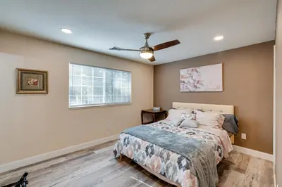 a bedroom with a bed and a ceiling fan at Renovated Pioneer Home in Serene Wooded Setting! in Pioneer