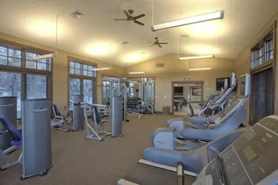 a gym with a bunch of chairs and machines at Luxury Northstar Home| hot tub| walk to ski lifts in Truckee