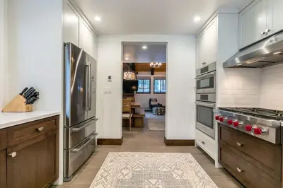 a kitchen with stainless steel appliances and a living room at North Lake Tahoe Cabin and Hot Tub in Tahoe City