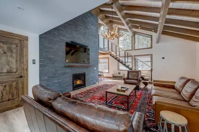 a living room with a leather couch and a fireplace at Extra Spacious 2BR Cabin w Office and Outdoor Deck in Incline Village