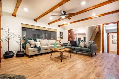 a living room with two couches and a table at Red Rock Falls Cabin, 8 miles from Yosemite South Gate, with trailhead, Game Room and HotTub in Oakhurst