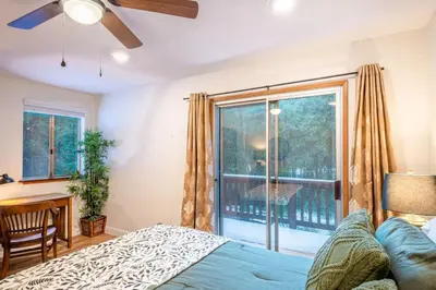 a bedroom with a bed and a large window at Red Rock Falls Cabin, 8 miles from Yosemite South Gate, with trailhead, Game Room and HotTub in Oakhurst