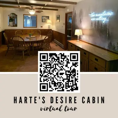 a living room with a table and a dining room at Harte's Desire Cabin - Lake, A/C, Arcade + in Twain Harte