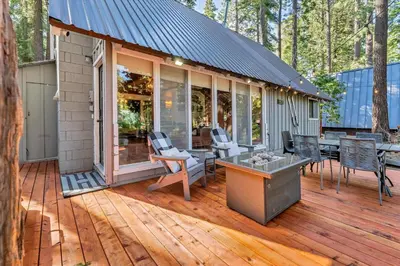 a screened in porch of a house with chairs and tables at The Rigi Chalet HOA Beach Access Close to town in Tahoe City