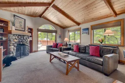 a living room with a couch and a table at Modern 3BR Tahoe Cabin with Hot Tub in Tahoe City