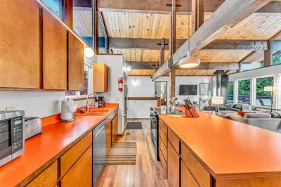 an open kitchen with orange counter tops and wooden cabinets at Carnelian Bay Retreat with Deck & Bonus Room in Carnelian Bay