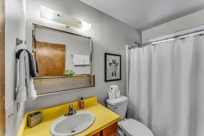 a bathroom with a sink and a toilet and a mirror at Carnelian Bay Retreat with Deck & Bonus Room in Carnelian Bay