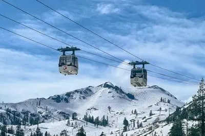 two gondolas on a ski lift over a snow covered mountain at Mt Airy Cottage Walk to Beach in Tahoe Vista